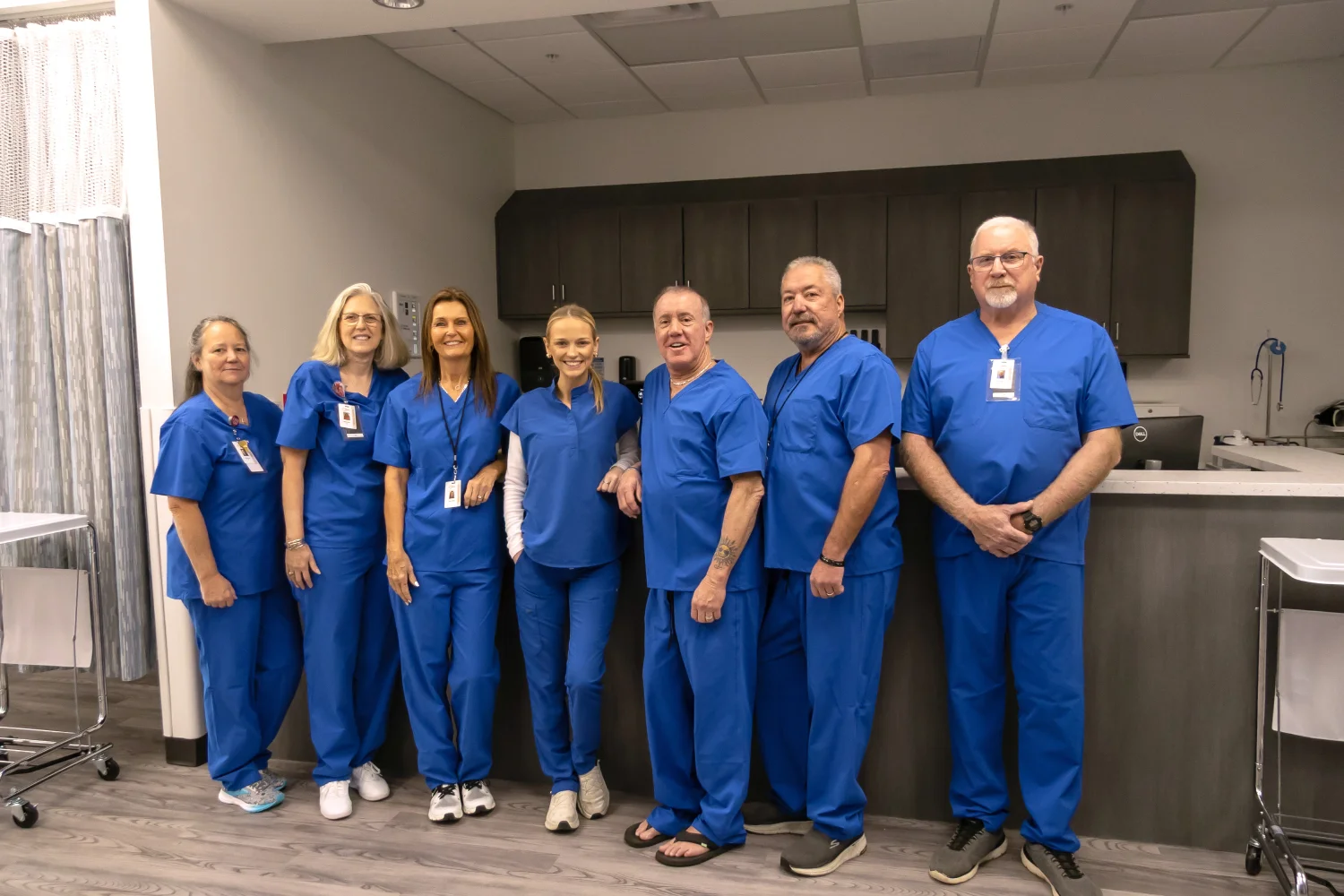 The care team of Jeffrey G. Tauth, M.D., F.A.C.C. in scrubs